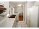 Galley kitchen with a view into the dining area at 21094 Edgewater Dr, Port Charlotte, FL 33952