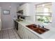 Clean kitchen, featuring a double sink and electric range at 21094 Edgewater Dr, Port Charlotte, FL 33952