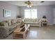 Living room with two sofas, coffee table, and ceiling fan at 21094 Edgewater Dr, Port Charlotte, FL 33952