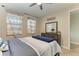 Charming bedroom with a double bed, dresser, and stylish striped bedding at 21391 Harborside Blvd, Port Charlotte, FL 33952