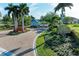 Gated entrance to community with lush landscaping and guardhouse at 21391 Harborside Blvd, Port Charlotte, FL 33952