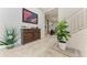 Bright entryway with tiled floors, wood console table, and large plants at 21391 Harborside Blvd, Port Charlotte, FL 33952