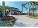 Two-story home with palm trees and a long driveway at 21391 Harborside Blvd, Port Charlotte, FL 33952