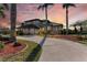 Two-story home with palm trees and a circular driveway at 21391 Harborside Blvd, Port Charlotte, FL 33952