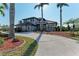 Two-story home with circular driveway and lush landscaping at 21391 Harborside Blvd, Port Charlotte, FL 33952