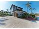 Two-story home with attached garage and lush landscaping at 21391 Harborside Blvd, Port Charlotte, FL 33952