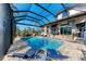 Inviting pool area with covered lanai and lounge chairs at 21391 Harborside Blvd, Port Charlotte, FL 33952