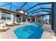 Large screened-in pool with patio furniture at 21391 Harborside Blvd, Port Charlotte, FL 33952