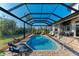 Enclosed pool and patio with multiple seating areas at 21391 Harborside Blvd, Port Charlotte, FL 33952