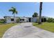 Front view of house showcasing the driveway and landscaping at 217 W Tarpon Nw Blvd, Port Charlotte, FL 33952