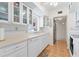 White kitchen with tiled floor, double sink, and glass cabinets at 217 W Tarpon Nw Blvd, Port Charlotte, FL 33952