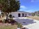 One-story home with a white exterior, landscaping, and a two-car garage at 2219 Bengal Ct, Punta Gorda, FL 33983