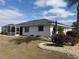 Rear view of a single-story home showcasing the backyard landscape at 2219 Bengal Ct, Punta Gorda, FL 33983