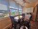 Sunlit dining area, table, chairs, and view at 2290 Aaron St # 302, Port Charlotte, FL 33952