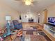 Living room with comfy seating and large TV at 2290 Aaron St # 302, Port Charlotte, FL 33952