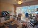 Living room with wood floors, open layout, and view to the dining area at 2290 Aaron St # 302, Port Charlotte, FL 33952