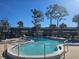 Community pool with surrounding lounge chairs at 2290 Aaron St # 302, Port Charlotte, FL 33952