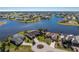 Aerial view of a lakefront community featuring upscale homes at 24337 Contra Costa Ln, Punta Gorda, FL 33955