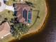 Aerial view of a home with a pool and solar panels near the lake at 24337 Contra Costa Ln, Punta Gorda, FL 33955