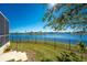 Landscaped backyard with lake view and a black metal fence at 24337 Contra Costa Ln, Punta Gorda, FL 33955