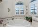 Round bathtub with tile surround and window at 24337 Contra Costa Ln, Punta Gorda, FL 33955