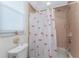 Small bathroom with flamingo shower curtain at 24337 Contra Costa Ln, Punta Gorda, FL 33955