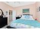 Bedroom with full-size bed and access to the bathroom at 24337 Contra Costa Ln, Punta Gorda, FL 33955