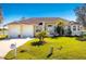 Single-story house with a two-car garage and manicured lawn at 24337 Contra Costa Ln, Punta Gorda, FL 33955