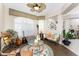 Living room with ample natural light, comfy seating, and a circular rug at 24337 Contra Costa Ln, Punta Gorda, FL 33955