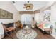 Cozy living room featuring a fireplace, comfy seating, and a circular rug at 24337 Contra Costa Ln, Punta Gorda, FL 33955