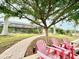 Relaxing patio with brick pathway and red chairs at 310 Belvedere Ct, Punta Gorda, FL 33950