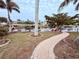 Landscaped backyard with canal view and brick pathway at 310 Belvedere Ct, Punta Gorda, FL 33950