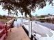 Private dock with two red chairs and a covered boat at 310 Belvedere Ct, Punta Gorda, FL 33950