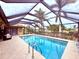 Enclosed heated pool with a covered patio and seating area at 310 Belvedere Ct, Punta Gorda, FL 33950