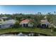 Aerial view of houses and a pond at 3191 Village Ln, Port Charlotte, FL 33953