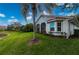 Home exterior showcasing a pond view and lush landscaping at 3191 Village Ln, Port Charlotte, FL 33953