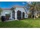 House exterior showcasing a large backyard and screened patio at 3191 Village Ln, Port Charlotte, FL 33953