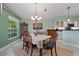 Bright dining area with a table, chairs, and view to the kitchen at 3191 Village Ln, Port Charlotte, FL 33953