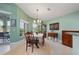 Elegant dining room features a table for six and large windows at 3191 Village Ln, Port Charlotte, FL 33953