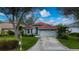 Single-story home with tile roof, attached garage, and landscaped yard at 3191 Village Ln, Port Charlotte, FL 33953