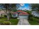 One-story house featuring a tile roof and a well-manicured lawn at 3191 Village Ln, Port Charlotte, FL 33953