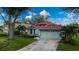 Single-story home with attached garage and red tile roof at 3191 Village Ln, Port Charlotte, FL 33953