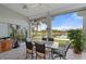 Screened lanai with lake view, table and chairs, perfect for relaxing at 3191 Village Ln, Port Charlotte, FL 33953