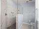 Walk-in shower with marble tile and built-in shelving at 3191 Village Ln, Port Charlotte, FL 33953