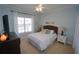 Bright bedroom with a queen-size bed, large window, and ceiling fan at 3216 Purple Martin Dr # 123, Punta Gorda, FL 33950