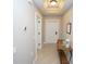 Bright hallway with tiled floors and a console table at 3216 Purple Martin Dr # 123, Punta Gorda, FL 33950