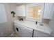 Laundry room with washer, dryer, cabinets, and a utility sink at 3216 Purple Martin Dr # 123, Punta Gorda, FL 33950