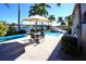 Inviting pool area with patio furniture and umbrella at 3216 Purple Martin Dr # 123, Punta Gorda, FL 33950