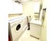 Laundry room with washer, dryer, cabinets and utility sink at 3311 Wood Thrush Dr # 111, Punta Gorda, FL 33950