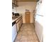 View of kitchen with wood cabinetry and tiled floor at 4008 Oakview Dr # K3, Punta Gorda, FL 33980